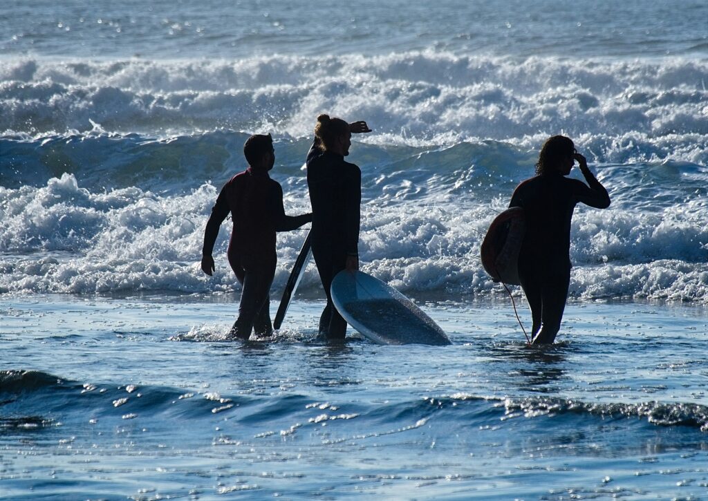 Three men while surfing in sea